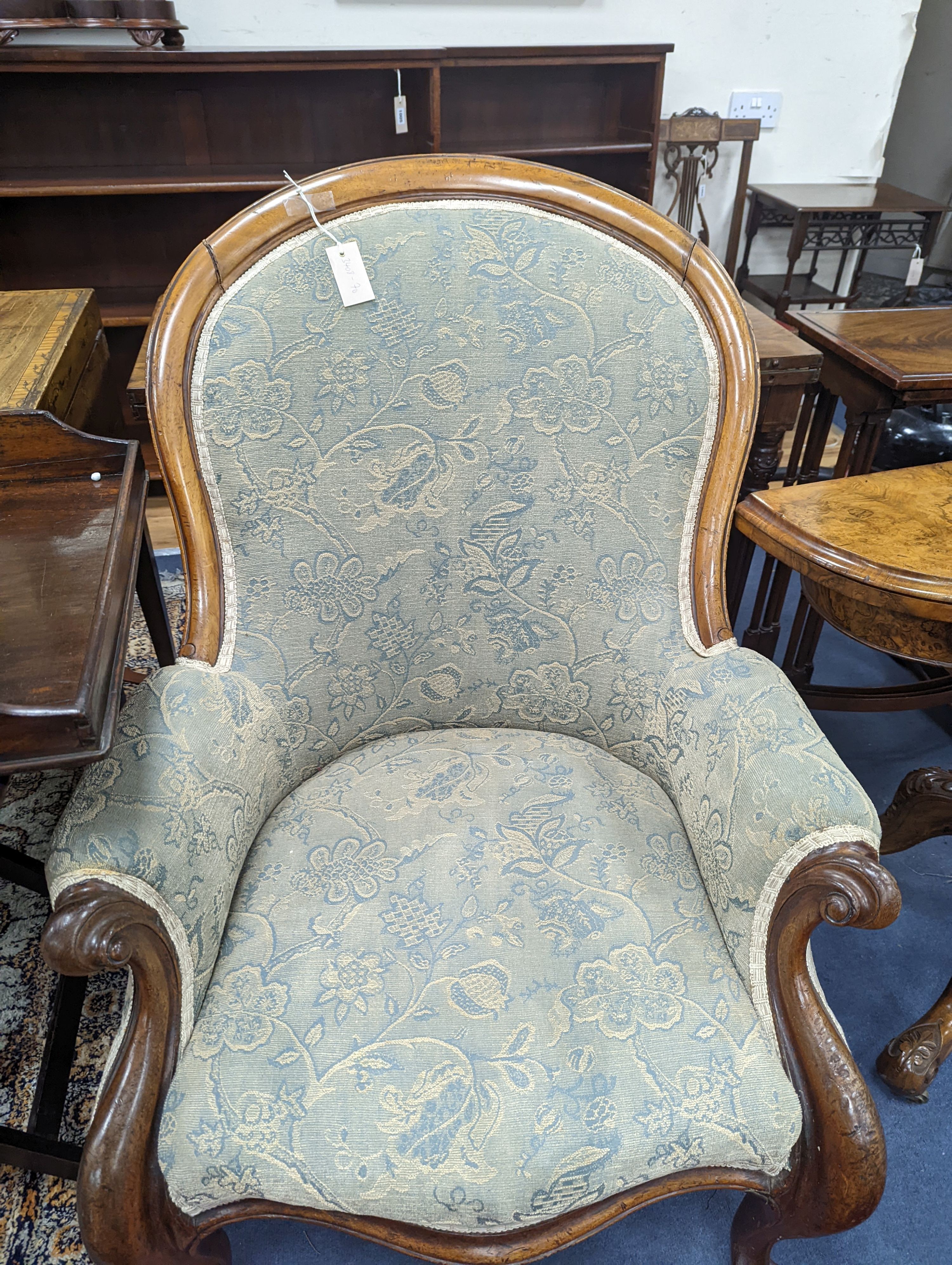 An upholstered Victorian armchair